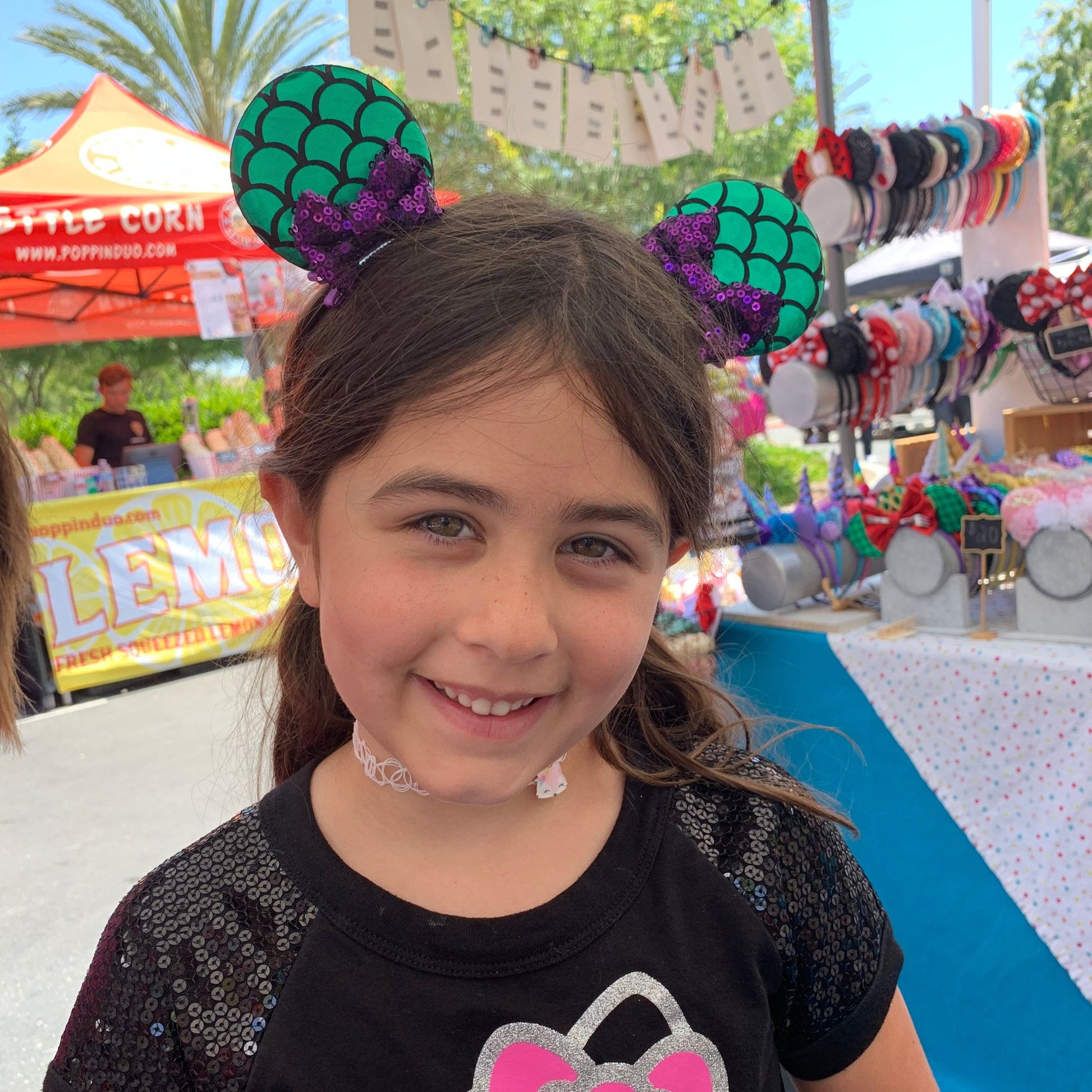 little girl wearing mermaid mouse ear clips 